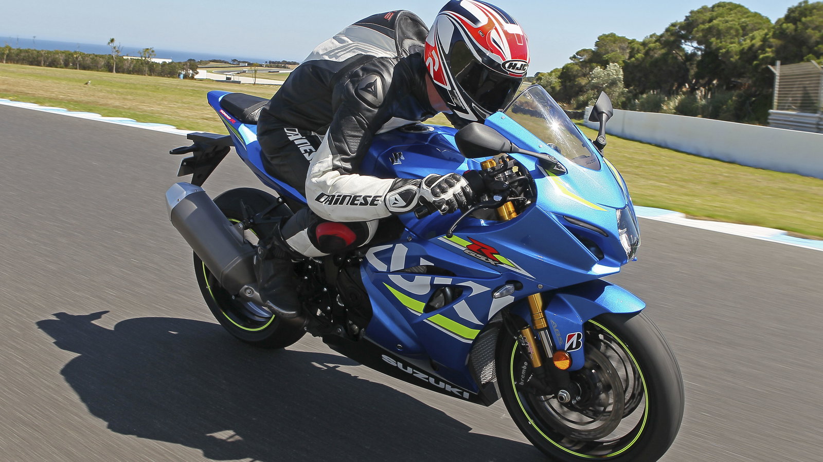 A blue 2017 Suzuki GSX-R1000R being ridden on a track